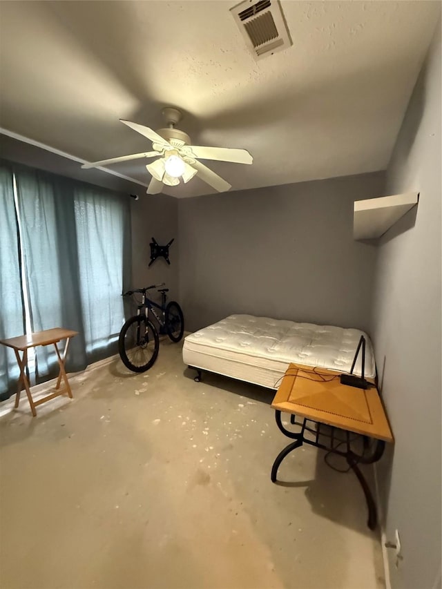bedroom featuring visible vents, a ceiling fan, and concrete flooring