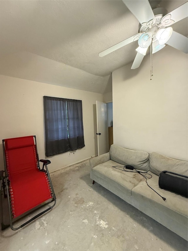 living room featuring ceiling fan and unfinished concrete flooring