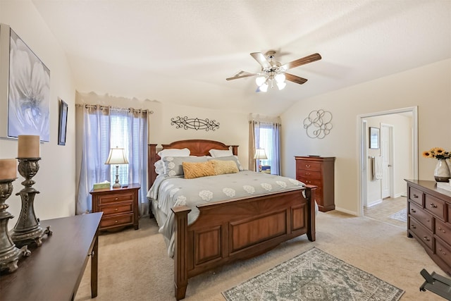 bedroom featuring a ceiling fan, multiple windows, lofted ceiling, and light carpet