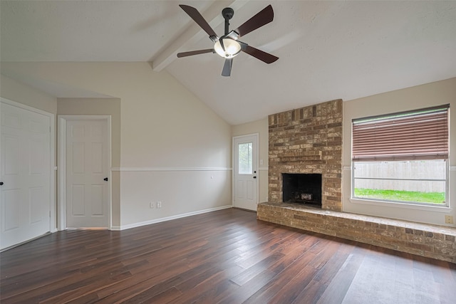 unfurnished living room with ceiling fan, a brick fireplace, baseboards, vaulted ceiling with beams, and hardwood / wood-style flooring