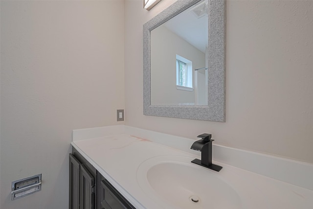 bathroom with vanity and visible vents