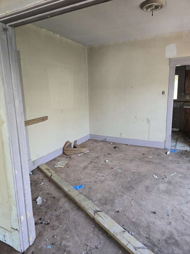 unfurnished room featuring baseboards