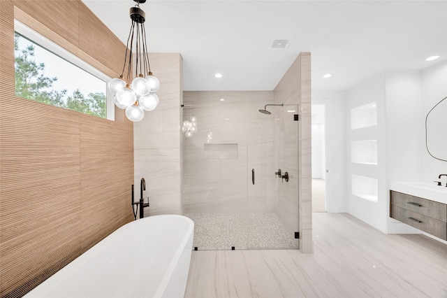 bathroom featuring visible vents, a freestanding bath, a shower stall, vanity, and recessed lighting