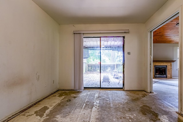 empty room featuring baseboards and a tile fireplace