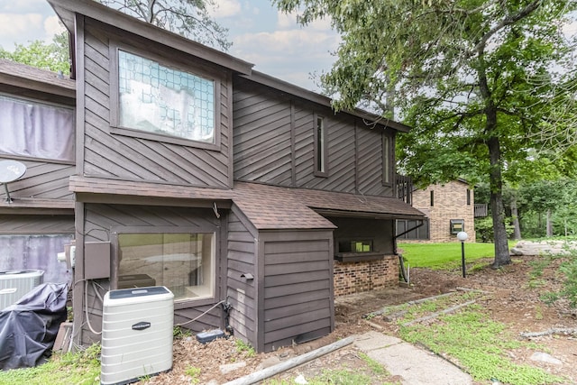 rear view of property with central AC