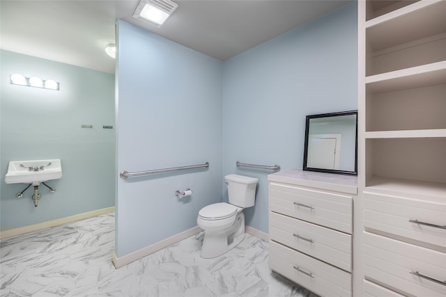 303 S Mechanic St, Fayetteville, TX 78940 - bathroom featuring toilet, baseboards, and marble finish floor