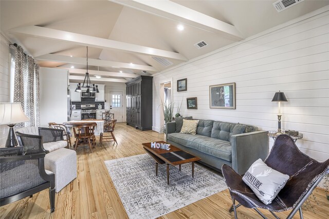 303 S Mechanic St, Fayetteville, TX 78940 - living area featuring wooden walls, visible vents, and light wood-style floors