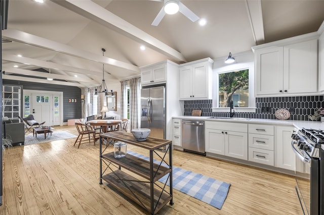 303 S Mechanic St, Fayetteville, TX 78940 - kitchen featuring a sink, appliances with stainless steel finishes, white cabinets, and lofted ceiling with beams