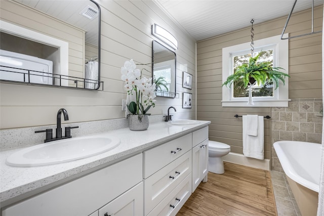 303 S Mechanic St, Fayetteville, TX 78940 - bathroom with toilet, a washtub, visible vents, and a sink