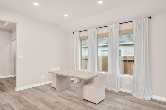 unfurnished office featuring light wood-style floors, baseboards, recessed lighting, and lofted ceiling