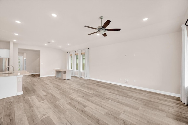 unfurnished living room featuring recessed lighting, a ceiling fan, baseboards, and light wood finished floors