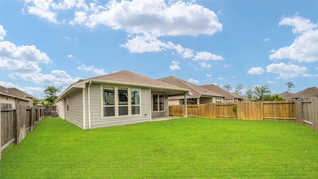 back of property featuring a lawn, a fenced backyard, and a patio area