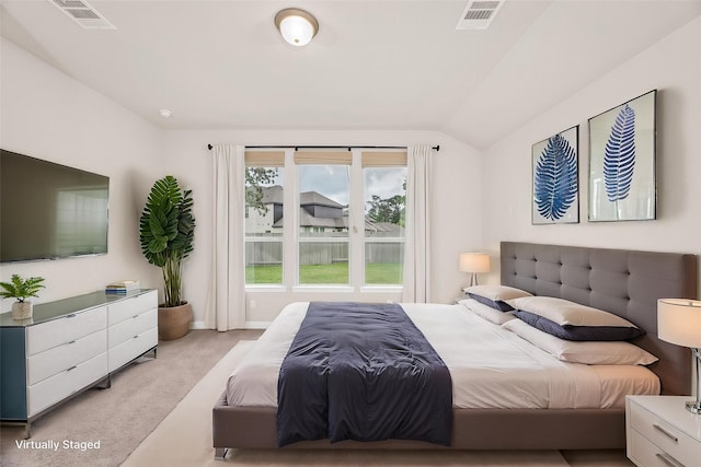 bedroom with vaulted ceiling, baseboards, carpet flooring, and visible vents