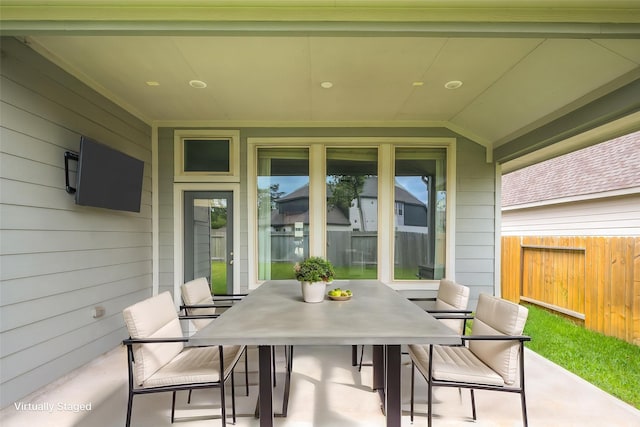 view of patio featuring fence and outdoor dining space