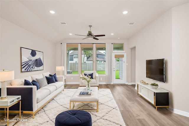 living room with a ceiling fan, visible vents, wood finished floors, baseboards, and recessed lighting