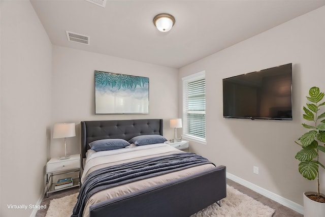 bedroom with baseboards, carpet floors, and visible vents