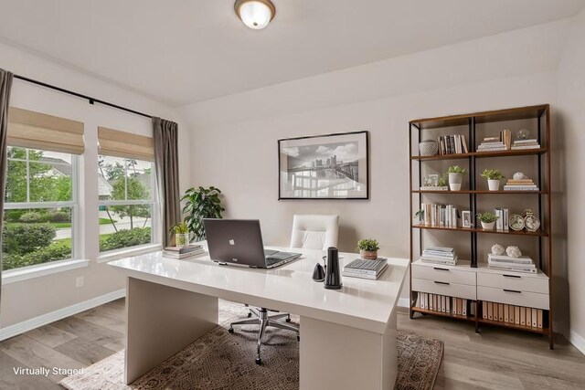 office space with baseboards and wood finished floors