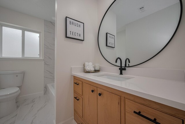 bathroom featuring vanity, toilet, marble finish floor, baseboards, and visible vents