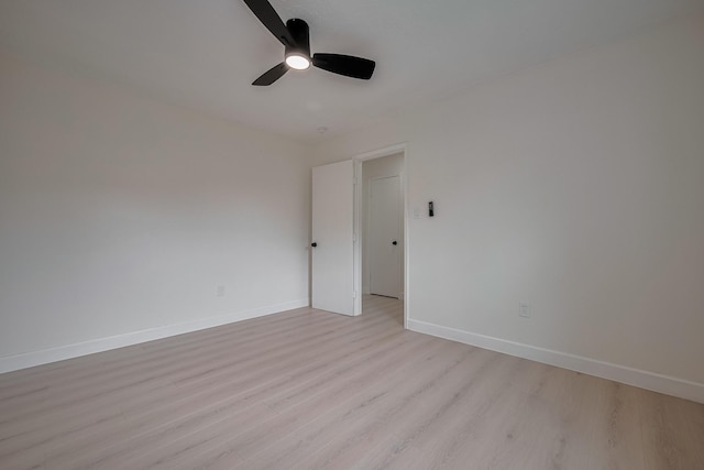 empty room with light wood-style floors, baseboards, and ceiling fan