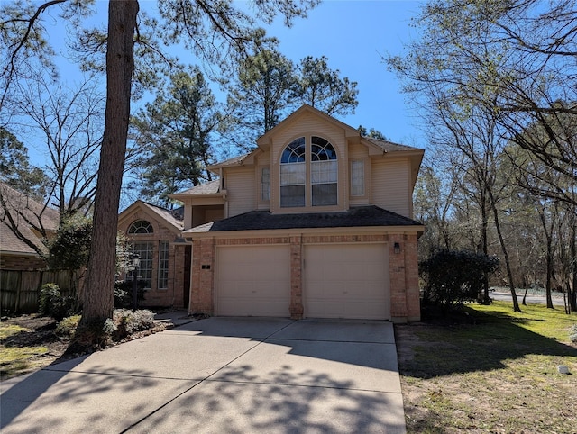 traditional-style home featuring brick siding, driveway, and a garage