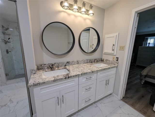 2 Skyland Pl, The Woodlands, TX 77381 - bathroom featuring marble finish flooring, double vanity, connected bathroom, a marble finish shower, and baseboards