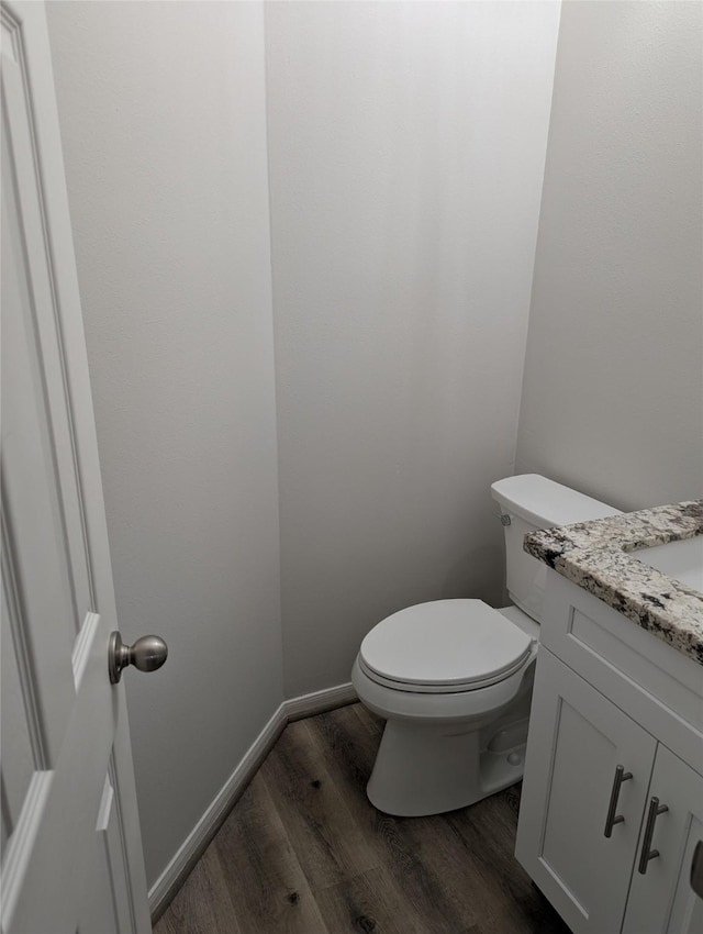 2 Skyland Pl, The Woodlands, TX 77381 - bathroom featuring wood finished floors, vanity, and toilet