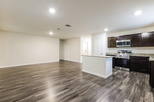 kitchen featuring a kitchen island, visible vents, appliances with stainless steel finishes, dark wood-style floors, and open floor plan