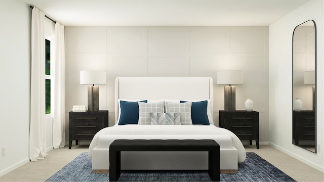 bedroom featuring baseboards, a decorative wall, and light colored carpet