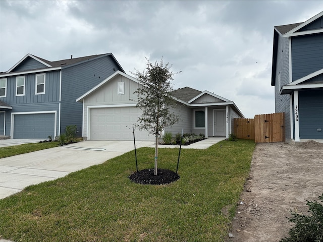 12410 Lady Slipper Rd, Houston, TX 77038 - view of front of house featuring board and batten siding, driveway, a gate, and a garage