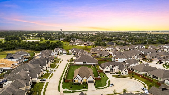 aerial view at dusk featuring a residential view
