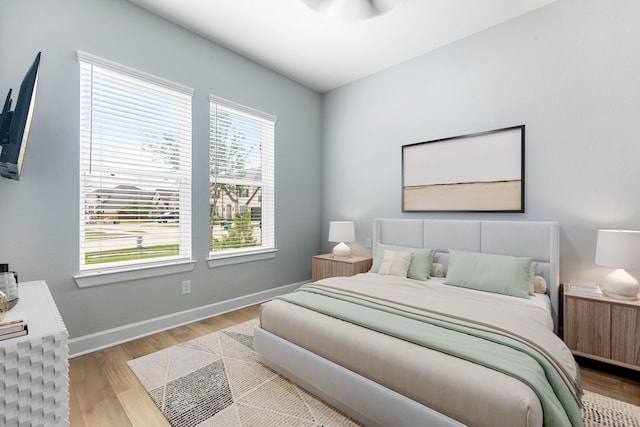 bedroom featuring baseboards and wood finished floors