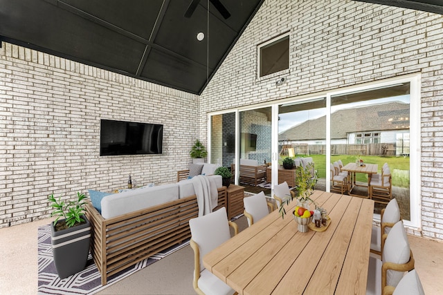 view of patio with outdoor dining area, a ceiling fan, and outdoor lounge area
