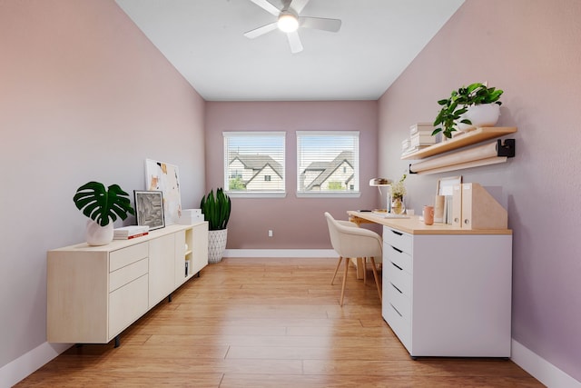 office area with baseboards, ceiling fan, and light wood-style flooring