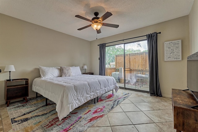 bedroom featuring light tile patterned floors, ceiling fan, a textured ceiling, and access to exterior