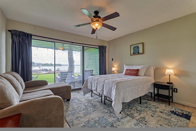 bedroom featuring access to outside, a textured ceiling, ceiling fan, and baseboards