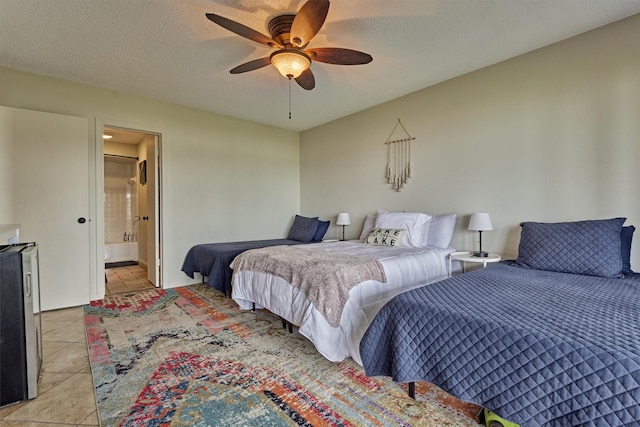 bedroom featuring ceiling fan, light tile patterned flooring, and connected bathroom