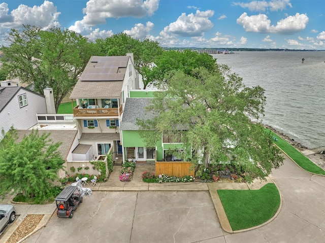 birds eye view of property with a water view