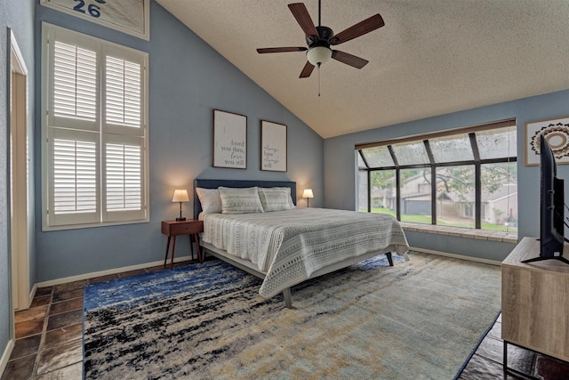 bedroom with baseboards, a ceiling fan, vaulted ceiling, and a textured ceiling