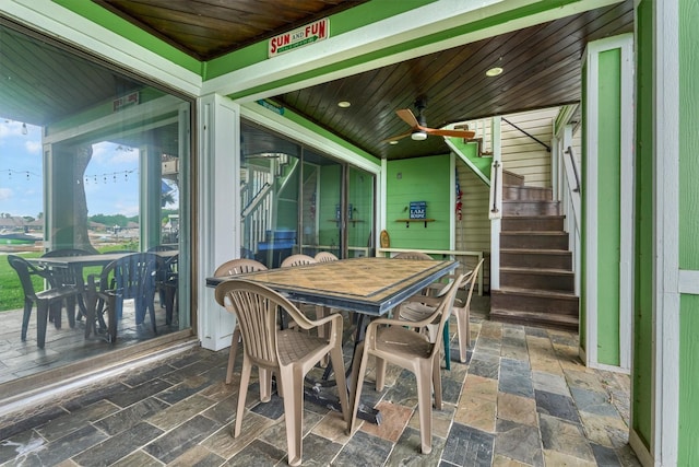 sunroom featuring outdoor dining space and ceiling fan
