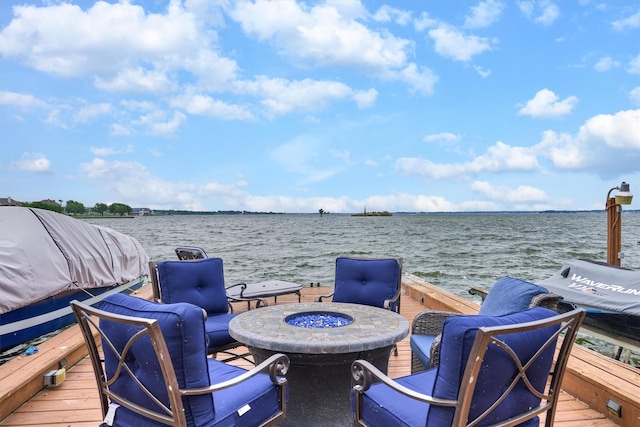 dock area with a water view and a fire pit