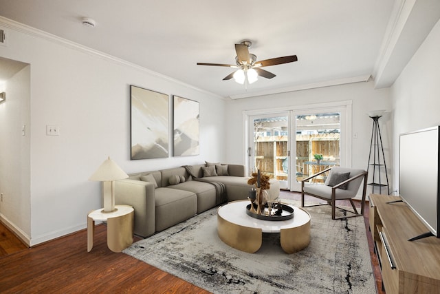 living room with ornamental molding, baseboards, a ceiling fan, and wood finished floors
