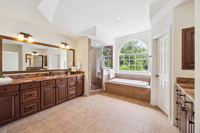 bathroom with tile patterned floors, a garden tub, vanity, and a stall shower