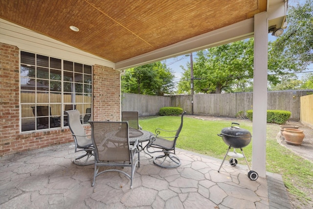 view of patio / terrace featuring area for grilling, outdoor dining area, and a fenced backyard