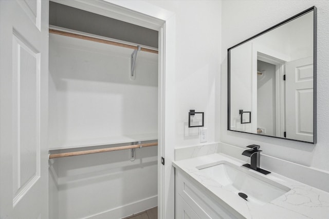 bathroom featuring vanity and a spacious closet