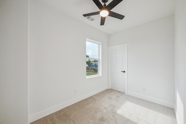unfurnished room featuring visible vents, a ceiling fan, baseboards, and light carpet