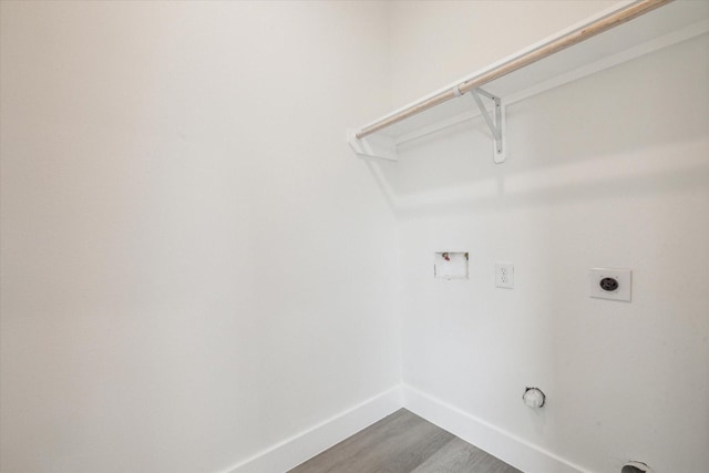 laundry area featuring laundry area, hookup for a washing machine, electric dryer hookup, baseboards, and dark wood-type flooring