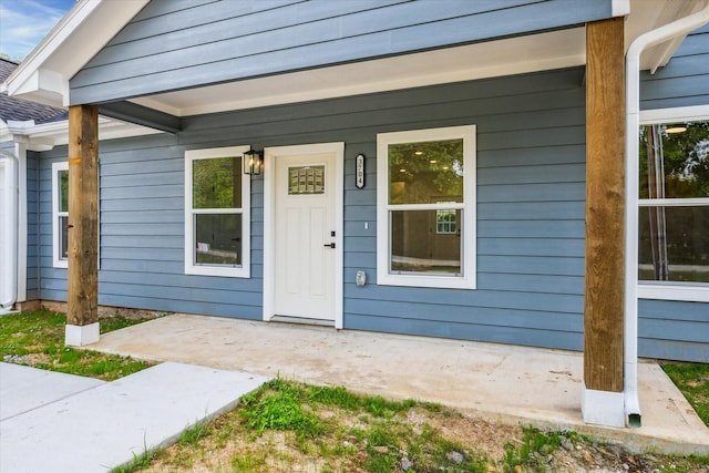 view of exterior entry with a porch