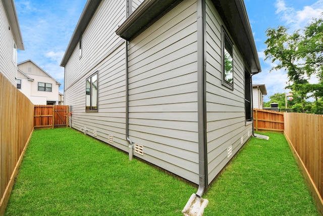 view of property exterior featuring a fenced backyard and a yard