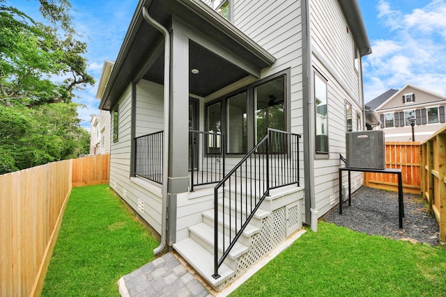 view of side of property featuring a fenced backyard and a yard