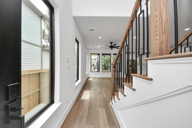 interior space with ceiling fan, recessed lighting, baseboards, wood finished floors, and visible vents